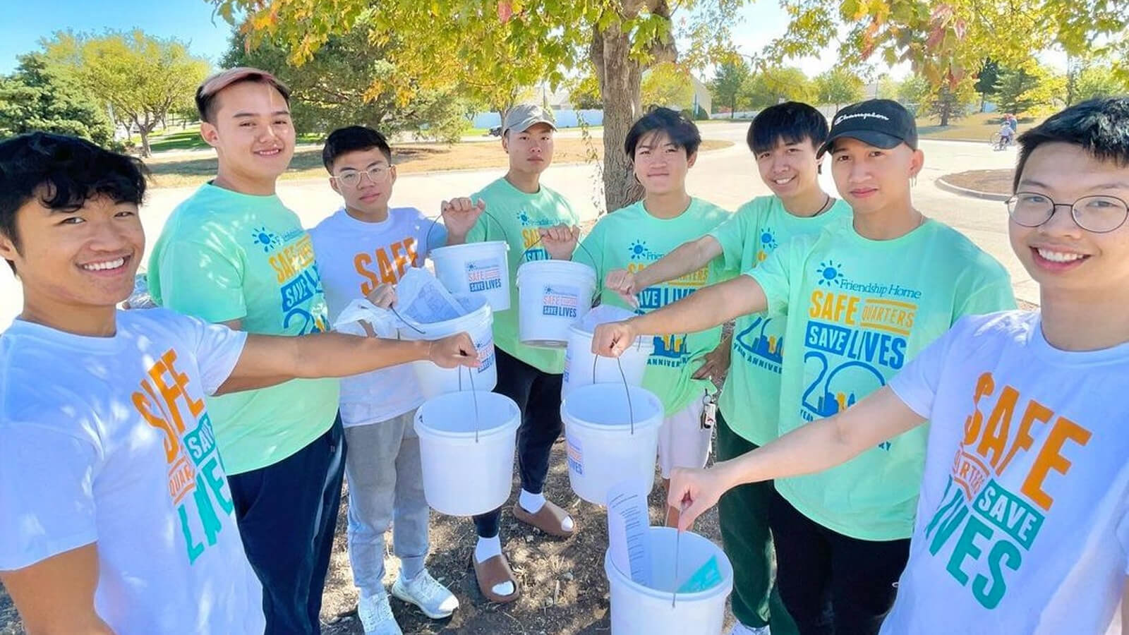 Students holding buckets for collecting money