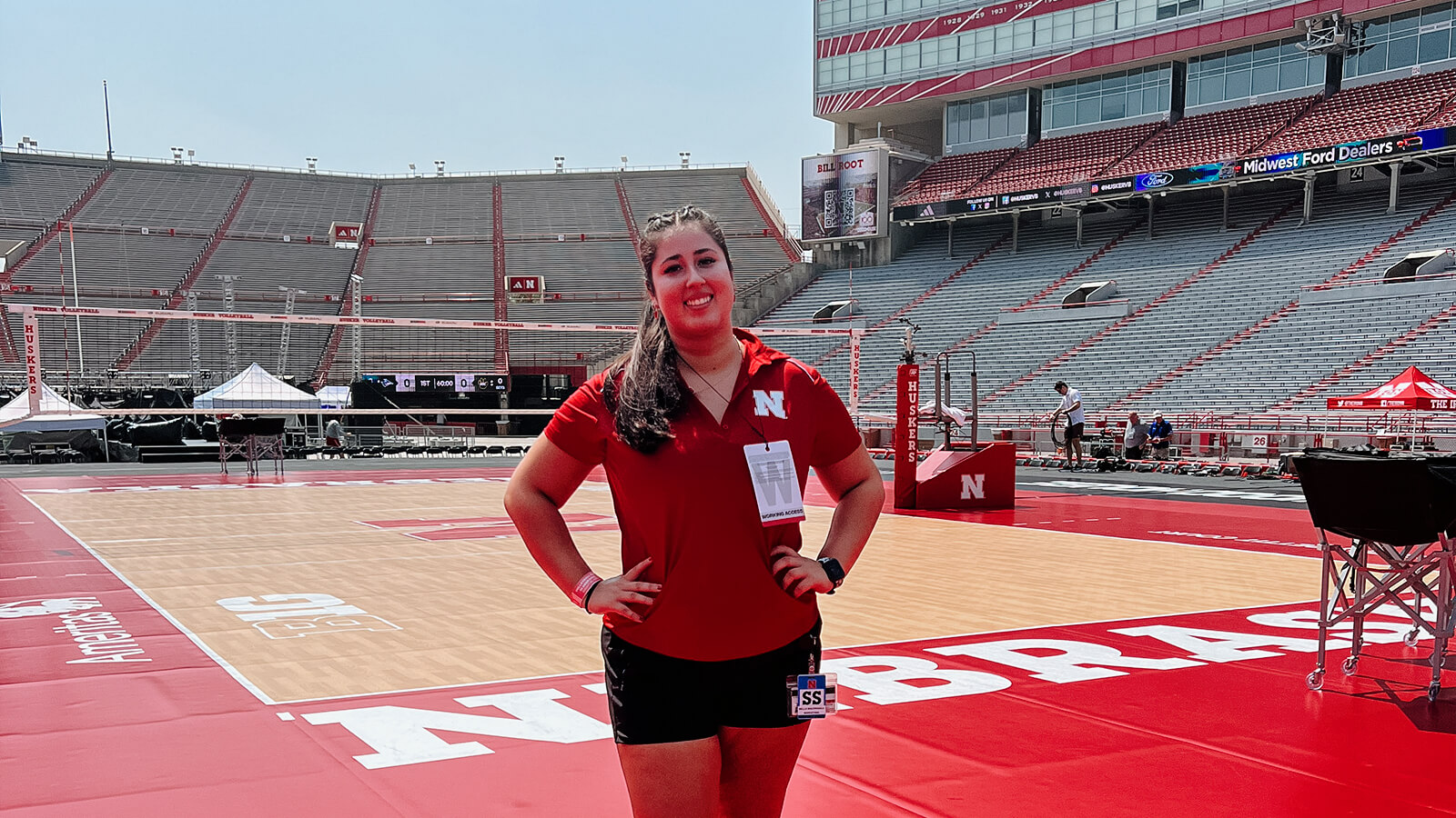 Student standing on court in Memorial Stadium for Volleyball Day