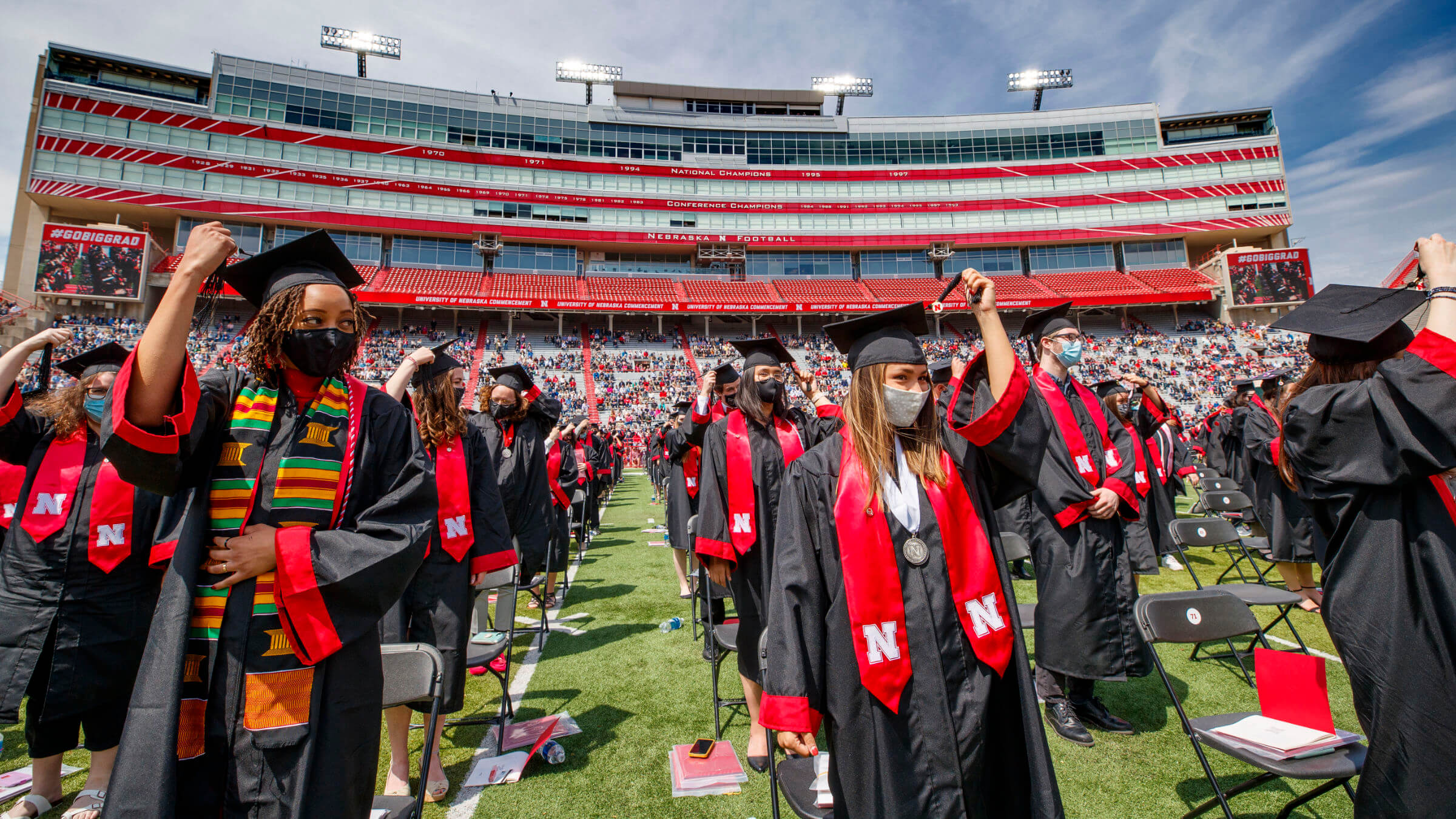 Students flipping their tassel during commencement in Memorial Stadium