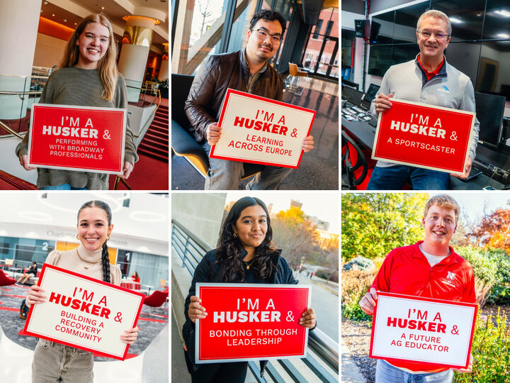 Huskers holding boards saying "I'm a Husker &"