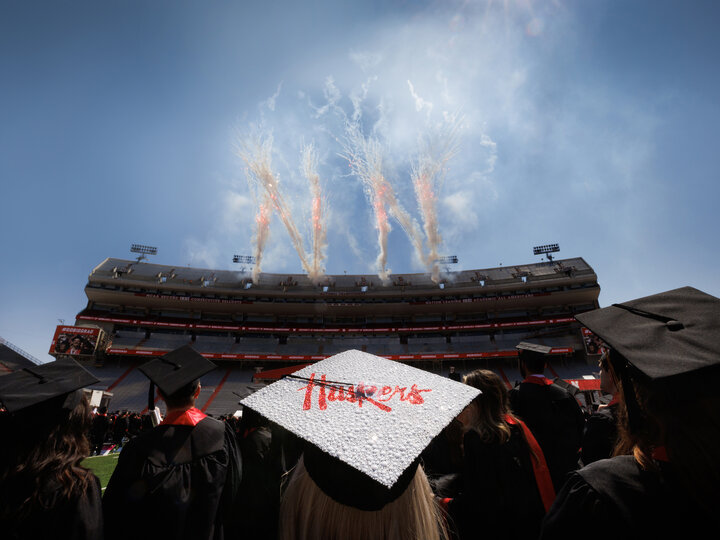 Ashtyn Tridle watches the fireworks at the conclusion of commencement at Memorial Stadium