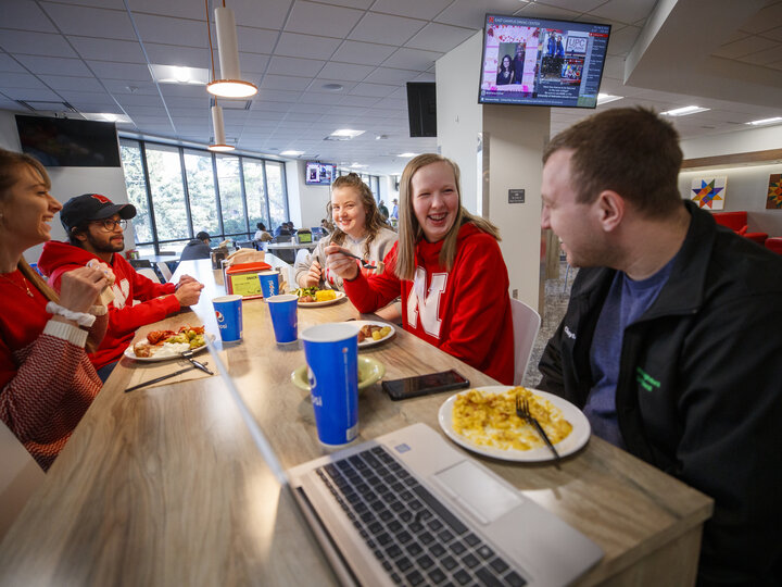 Students eating and socializing at the East Campus Dining Center