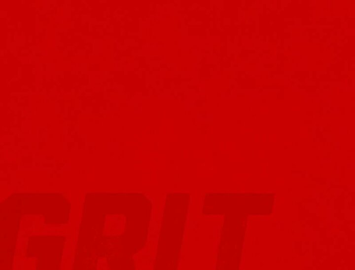 Grit in dark red on red background.