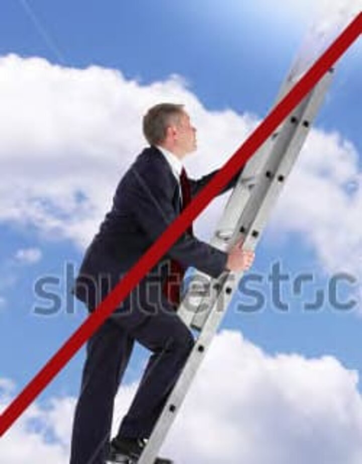 Businessman climbing ladder up in the clouds with red line photo