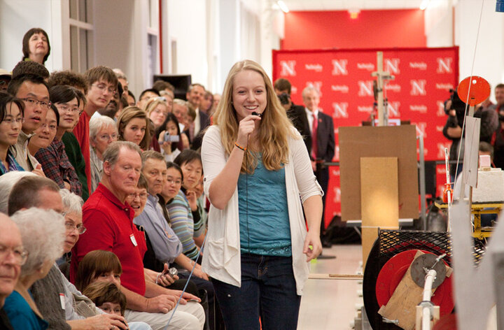 A woman speaking to a large crowd