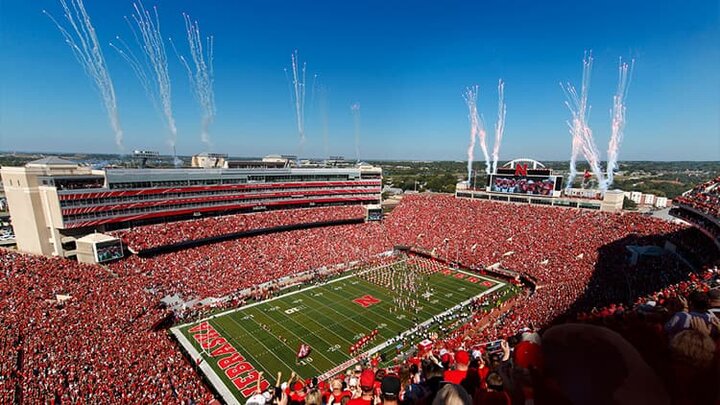 A shot of Memorial Stadium filled with Husker fans and fireworks going off.