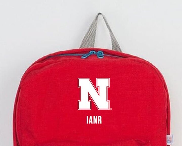 N logo IANR wordmark on red backpack