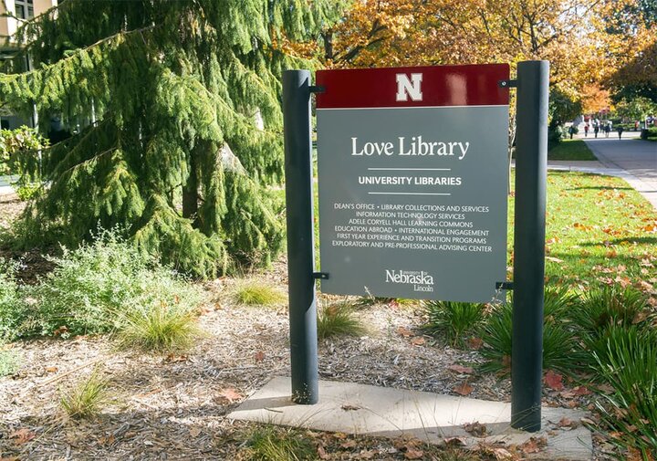 Metal outdoor signage with N logo reading Love Library