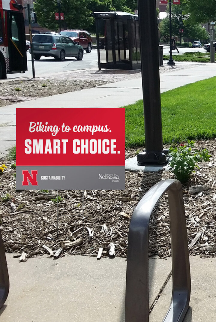 A yard-sign-style sign next to a bicycle rack